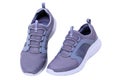 Closeup of a pair of modern silver gray sneakers or sports shoes isolated on a white background. Clipping path. Elegant and trendy