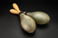 A pair of rawhide maracas lying on a black underground Royalty Free Stock Photo