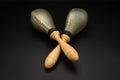 A pair of rawhide maracas lying on a black underground Royalty Free Stock Photo