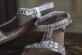 Closeup of a pair of silver bridal shoes with rhinestones