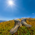 Closeup pair of touristic boot on a hill top