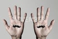 Moustache in man hands and text movember