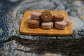 Closeup of pandan snow skin mooncakes served on a wooden serving board