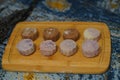 Closeup of pandan snow skin mooncakes served on a wooden serving board