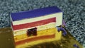 Closeup panorama on piece of violet glazed mousse cake with red jelly interlayer