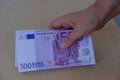 closeup paper 500 euro banknotes in hand on table, concept cash, payments, savings, banking, return money debt, car, win in casino Royalty Free Stock Photo