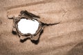 Closeup of old torn paper hole on white background with space for your text Royalty Free Stock Photo