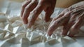 A closeup of a paper model in the process of being folded the creators hands deftly manipulating the paper as they Royalty Free Stock Photo