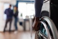 Closeup of paralyzed african american businesswoman hands in wheelchair Royalty Free Stock Photo