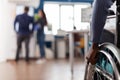 Closeup of paralyzed african american businesswoman hands in wheelchair Royalty Free Stock Photo