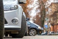 Closeup of parked car on a city street side with new winter rubber tires Royalty Free Stock Photo