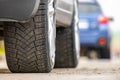 Closeup of parked car on a city street side with new winter rubber tires Royalty Free Stock Photo