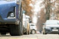 Closeup of parked car on a city street side with new winter rubber tires Royalty Free Stock Photo