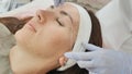 Closeup part of face depilation of eyebrows with a thread. Permanent tattooing of eyebrows. Royalty Free Stock Photo