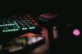 Closeup of a part of a glowing keyboard in the darkness.