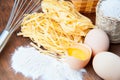 Closeup pasta, eggs and flour with whisk Royalty Free Stock Photo
