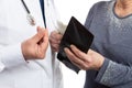 Closeup of patient putting money inside wallet and corrupt medic