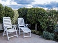 Closeup of patio furniture, two comfortable plastic loungers in the beautiful garden Royalty Free Stock Photo