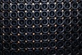 Closeup pattern from bottom of old dark dusty wine bottles in rows in cellar, basement, wine warehouse, winery. Concept Royalty Free Stock Photo