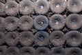 Closeup pattern from bottom of old dark dusty wine bottles in rows in cellar, basement, wine warehouse, winery. Concept Royalty Free Stock Photo