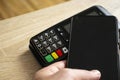 Closeup of payment terminal with banking concept, visible keypad.