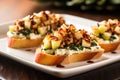 closeup of pear bruschetta on a square plate