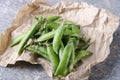 Closeup of peas in pods on the paper.Healthy eating, quick organic snack