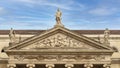 Closeup pediment of the Queen Maria II National Theater on Rossio Square in Lisbon, Portugal.