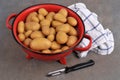 Closeup on peeler with potatoes in a colander Royalty Free Stock Photo