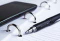 Pen, spiral notebook and cell phone Royalty Free Stock Photo