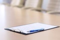 Closeup pen on table in empty corporate conference room before business meeting Royalty Free Stock Photo