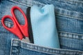 Pencilcase and scissors on blue jeans pocket Royalty Free Stock Photo