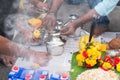 Closeup of people cooking food outdoors during the Thaipusam festival