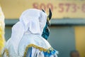 Closeup people in flamboyant costume pass by city street at dominican carnival