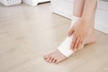Closeup People of a Foot with White Gauze Elastic Bandage. Hands on Injured Legs and Feet on Pain Area. Asian Young Woman Ankle