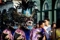 Closeup people in scary monster costume pass by city street at dominican carnival