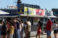 Closeup of people standing in a line at the boat cruise ticket booth along the coast of Barcelona