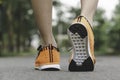 Closeup people walking with orange shoes on road in park for health concept Royalty Free Stock Photo