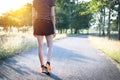 Closeup female walking with orange shoes on road in park for health concept Royalty Free Stock Photo