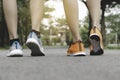 Closeup people walking with sport shoes on road in park for health concept