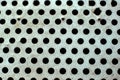Closeup perforated aluminium sheet of metal texture. Surface with depth of field, abstract industrial mesh. Top view Royalty Free Stock Photo