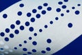 Closeup of perforated punched tape on blue background Royalty Free Stock Photo