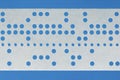 Closeup of perforated punched tape on blue background Royalty Free Stock Photo