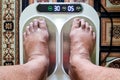 Closeup of person feet receiving magnetic therapy from electricity powered geomagnetic device, promising general well