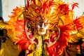 Closeup person in flamboyant costume poses for photo at dominican carnival