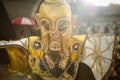 Closeup person in original mask poses for photo under rain at dominican carnival