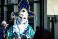 Closeup person in original pied costume walks by city street at dominican carnival