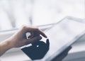 Closeup of a person pointing finger to a computer monitor with a blank screen blue against a background of window horizontal Royalty Free Stock Photo