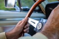 Closeup of person's hand driving a 1967 Mustang Shelby gt350