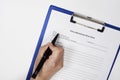 Closeup of a person signing a Vehicle Maintenance Work Order Form